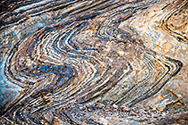 geological folds along riverbed mountains