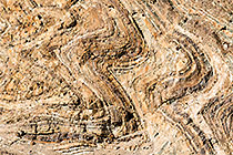 geological folds along riverbed mountains