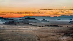 plain & mountains at sunset