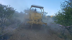 bulldozer making access road to plot