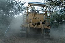 bulldozer making access road to plot