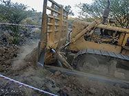 bulldozer making access road to plot