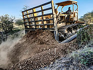bulldozer making access road to plot