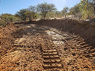 bulldozer making access road to plot
