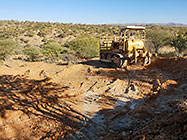 bulldozer making access road to plot
