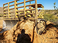 bulldozer making access road to plot
