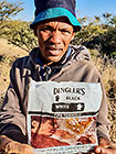 worker showing tabacco bag with strong advertising