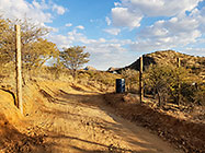 workers erecting 300 m fence around plot