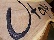 Utopia name carved on wood for sliding gate