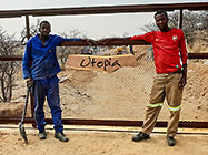Donald & Sedney showing freshly painted sliding gate with Utopia board