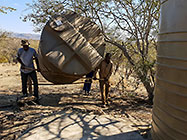 workers carrying 5000 l water tank