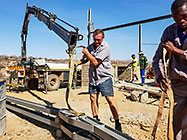 workers & crane truck erecting workshop steel portal