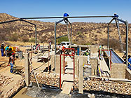 workers erecting workshop steel portal & bricklaying