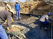 workers pooring concrete slab in gabion room