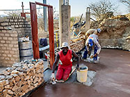 workers pooring concrete slab in gabion room