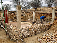 Sedney filling gabion basket with stones