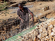 Donald filling top gabion baskets with stones before suspended slab