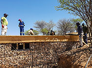Licius inspecting workers tiding steel bars on studio suspended slab over gabion room