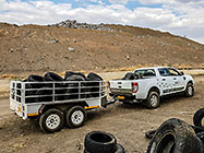 ranger with trailer full of tyres at dump site
