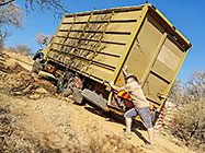 Paul holding 4x4 truck broken down on plot access road