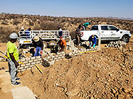 Licius workers building workshop foundation walls