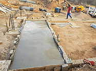 Donald & Sedney pooring concrete  next to workshop slab