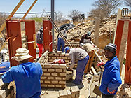Licius workers bricklaying workshop walls
