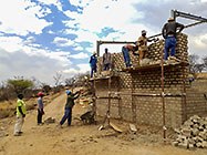 Licius workers bricklaying workshop walls