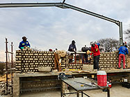 Licius workers bricklaying workshop walls