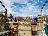 Licius workers bricklaying workshop walls