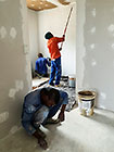 Donald & Sedney painting dry walls in studio