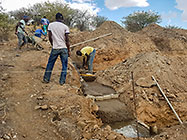 Bernard workers pooring concrete for house foundations