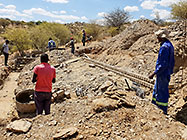 Bernard workers pooring concrete for house foundations