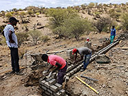 Bernard workers building house foundation walls