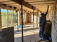 Sedney fixing house office ceiling with hessian over styroblocks