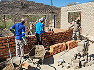 Bernard workers building house brick walls