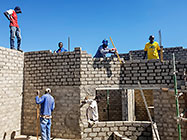 Bernard workers building house brick walls