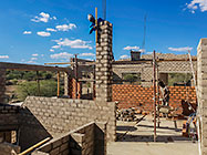 Bernard workers building house brick walls