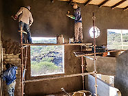 Bernard workers plastering house brick walls