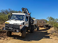 4x4 Unimog truck bringing house roof wooden beams