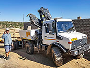 4x4 Unimog truck bringing house roof wooden beams