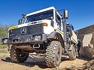 4x4 Unimog truck bringing house roof wooden beams