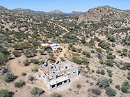 aerial view of 4x4 Unimog with crane installing house roof wooden beams