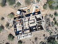 aerial view of 4x4 Unimog with crane installing house roof wooden beams