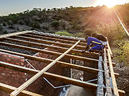 workers cleaning house roof wooden beams