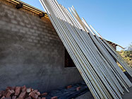 wooden perlines for roof standing on house wall
