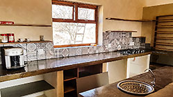 house kitchen countertops with prosopis wooden shelves, tiles, stove & oven