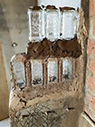 glass bottle feature in wall between house master bathroom & shower