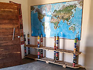 palette wood & tins sheves under world map in house entrance 