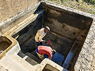 Donald & Sedney laying fiberglass mesh on house pool walls